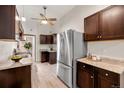 Modern kitchen with stainless steel appliances and dark wood cabinets at 1516 Lafayette St, Denver, CO 80218