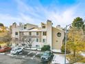 Front view of a two-story condominium building with parking and landscaping at 4070 S Atchison Way # 101, Aurora, CO 80014