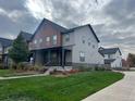 Modern townhome with gray siding, covered porch, and well-maintained lawn at 11137 E 25Th Ave, Aurora, CO 80010
