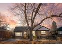 Brick ranch house with mature tree and landscaping at 3075 Elm St, Denver, CO 80207