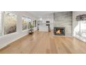 Open concept living room with hardwood floors and kitchen view at 3955 S Uinta St, Denver, CO 80237