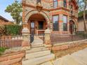 Steps leading to the front entrance with stonework and decorative iron railing at 3611-3615 Osage St, Denver, CO 80211