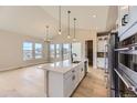 Modern kitchen with white cabinets, stainless steel appliances, and a large island with seating at 1881 Grayside Cir, Castle Rock, CO 80109