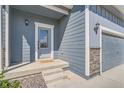 Two-story house with gray siding, attached garage, and landscaping at 18081 E 89Th Pl, Commerce City, CO 80022