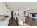 Spacious kitchen with large island and dark hardwood floors at 5134 Cupule Trl, Castle Rock, CO 80104