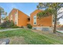 Front view of a two-story building with wood siding and landscaping at 4274 S Salida Way # 3, Aurora, CO 80013