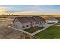 Ranch-style home with green exterior and landscaping at 59304 E Commanche Way, Strasburg, CO 80136