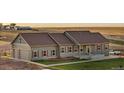 Ranch-style home with green exterior and landscaping at 59304 E Commanche Way, Strasburg, CO 80136