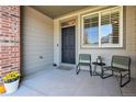 Inviting front porch with seating area, adding charm to the home at 2640 Cache Creek Ct, Castle Rock, CO 80108