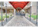 Condominium building entrance with covered walkway and seating at 2 Adams St # 1204, Denver, CO 80206