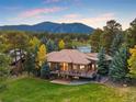 Backyard of luxury home with large deck and mountain views at 2768 Country Club Ln, Evergreen, CO 80439