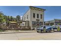 The Collegiate Brewing Company building with outdoor seating and branded vans parked out front at 281 Paloma Way, Elizabeth, CO 80107