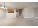 Bright dining area with carpet, light walls, and kitchen pass-through at 930 Button Rock Dr # J59, Longmont, CO 80504