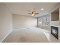 Living room features a fireplace, large windows and ceiling fan at 930 Button Rock Dr # J59, Longmont, CO 80504