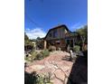 Back of house with patio, landscaping, and access to backyard at 757 S Vine St, Denver, CO 80209