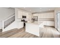 Modern kitchen featuring white cabinets, a large island, and stainless steel appliances at 4823 Astor Pl, Brighton, CO 80601