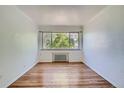 Bedroom with hardwood floors and large window at 85 N Grant St # 22, Denver, CO 80203