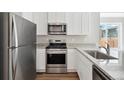 Modern kitchen with stainless steel appliances and granite countertops at 2460 Christina St, Fort Lupton, CO 80621