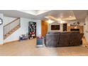 Finished basement with a fireplace, TV area, and stairs at 24087 Deer Valley Rd, Golden, CO 80401