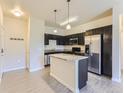 Modern kitchen with stainless steel appliances and island at 4100 Albion St # 512, Denver, CO 80216