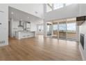 Open concept kitchen with white cabinets, large island, and stainless steel appliances at 3391 N Buchanan Way, Aurora, CO 80019