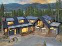 Modern home with mountain views and three-car garage; large windows and spacious driveway at 245 Fairways Dr, Breckenridge, CO 80424