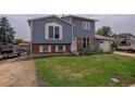 Two-story house with gray siding, attached garage, and RV parking at 614 Glenwood Dr, Lafayette, CO 80026