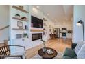 Open living room with modern fireplace and kitchen at 1998 Foxtail Ln # B, Lafayette, CO 80026