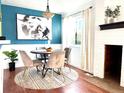 Dining room with a round table, four chairs, and a white brick fireplace at 10330 W Jewell Ave # A, Lakewood, CO 80232