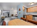 Dining area with wood table and chairs, open to kitchen and living room at 1260 York St # 105, Denver, CO 80206