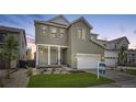 Two-story home with gray siding, white trim, and a two-car garage at 11076 Star Fall St, Littleton, CO 80125