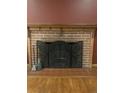Brick fireplace with ornate screen and wooden mantel at 1515 S Monaco Pkwy, Denver, CO 80224