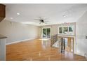 Bright and airy living room with hardwood floors and sliding glass doors at 13748 W Asbury Cir, Lakewood, CO 80228