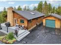 View of the log home from the side, showing its size and features at 6763 Deer Path, Evergreen, CO 80439