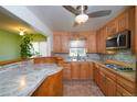 Bright kitchen with oak cabinets, granite countertops, and stainless steel appliances at 2862 N Monroe St, Denver, CO 80205