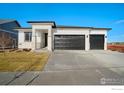 Modern two-story house with a three-car garage at 23845 E River Front Dr, Aurora, CO 80019