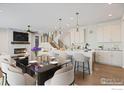 Open concept dining area with kitchen and living room views at 411 Blackfoot St, Superior, CO 80027