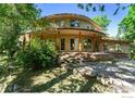 Round home with stone accents and a large covered porch at 824 Juniper Ave, Boulder, CO 80304