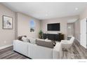 Living room with sofa and large TV at 270 S Cherrywood Dr # 101, Lafayette, CO 80026