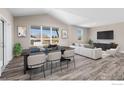 Open concept living and dining area with large windows and modern furnishings at 270 S Cherrywood Dr # 103, Lafayette, CO 80026