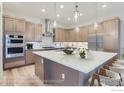 Modern kitchen with light wood cabinets and quartz countertops at 1765 Peak Loop, Broomfield, CO 80023