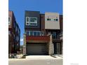 Contemporary townhome exterior with stone accents and a two-car garage at 733 Kubat Ln # B, Longmont, CO 80503