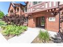 Brick building exterior with landscaping and entrance at 1379 Charles Dr # F5, Longmont, CO 80503