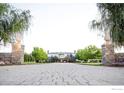 Long driveway leading to a grand estate with manicured landscaping at 7484 N 49Th St, Longmont, CO 80503