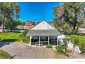 Covered patio with picnic table, nestled in a spacious backyard at 12027 Saint Vrain Rd, Longmont, CO 80504