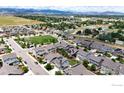 Neighborhood with houses, green spaces, and mountain views at 868 Ranchhand Dr, Berthoud, CO 80513