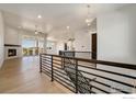 Open living room with hardwood floors, fireplace, and access to deck at 24113 E 36Th Pl, Aurora, CO 80019
