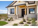 Front porch entrance with stone accents and wood pillars at 24113 E 36Th Pl, Aurora, CO 80019