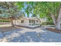 Charming ranch home with mature trees and gravel landscaping at 1834 Meadow Ln, Longmont, CO 80501