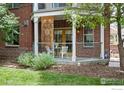 Private patio with brick wall and small table and chairs at 1560 Milwaukee St # 140, Denver, CO 80206